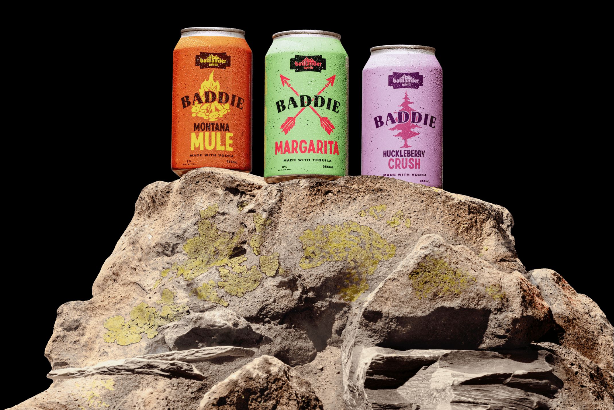 Badlander canned cocktails on a rock.